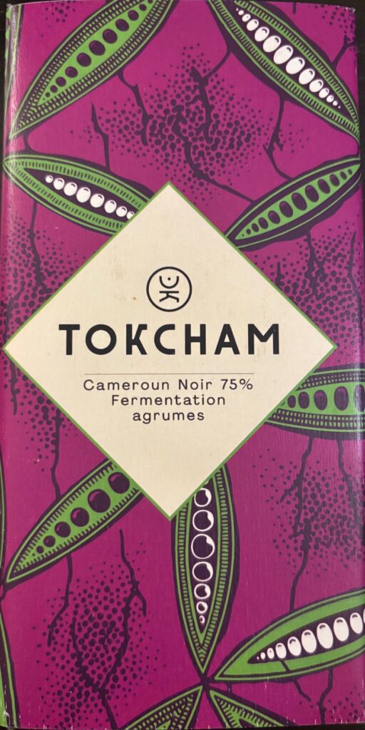 75% dark chocolate bar from Cameroon with magenta colored paper packaging with green colored cocoa beans