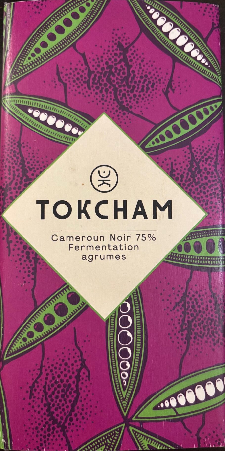 75% dark chocolate bar from Cameroon with magenta colored paper packaging with green colored cocoa beans