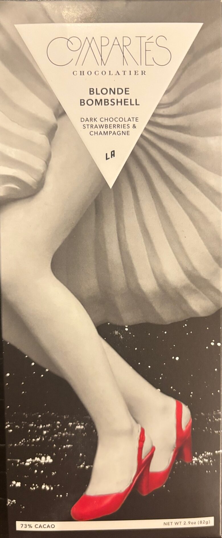 Compartes Chocolate 'California Dreaming' with 73% Dark Chocolate Strawberries and Champagne. Front Packaging with woman in big flowy skirt and red heels.