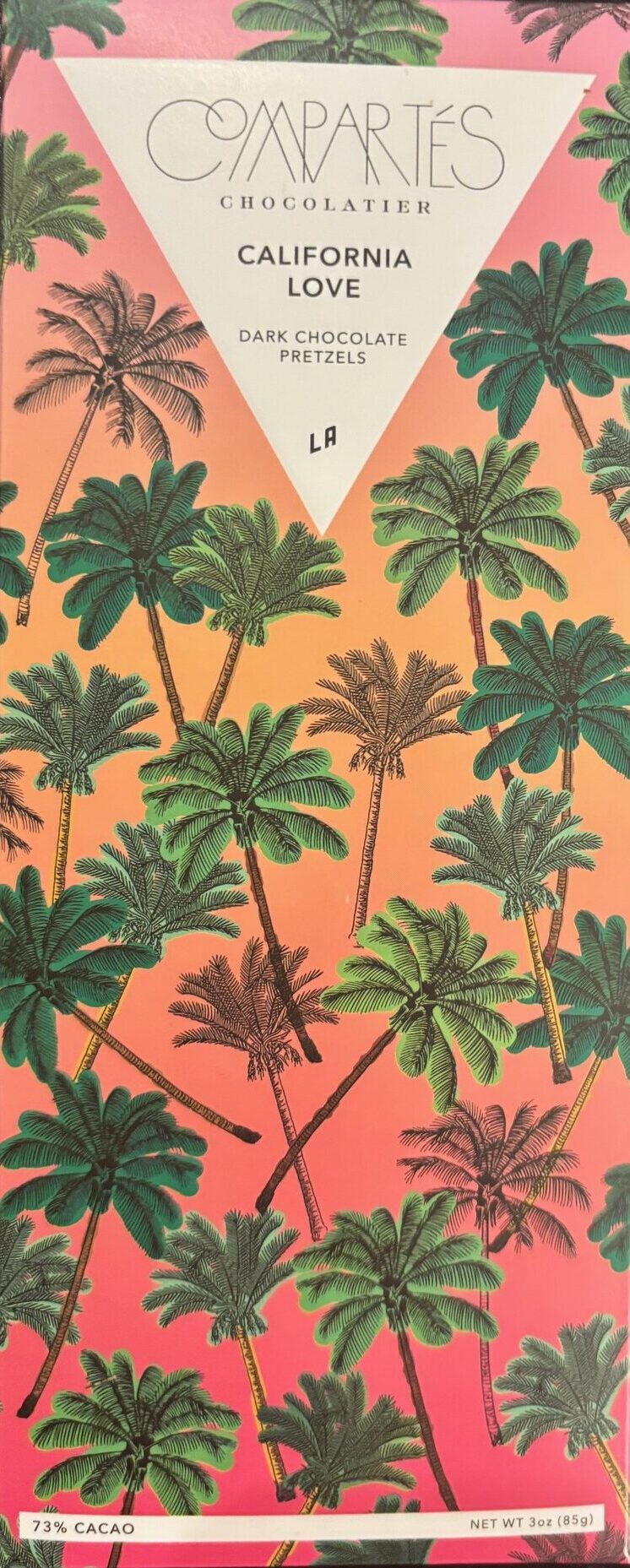Compartes Chocolate 'California Love' with 73% Dark Chocolate Pretzels. Front Packaging with pink and orange background and many palm trees in the foreground.