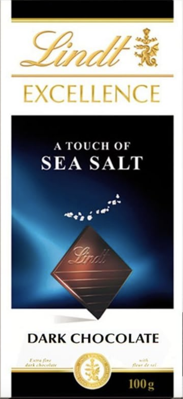 Front packaging of Lindt Dark Chocolate A Touch of Sea Salt. Image of a Lindt Chocolate square and some sea salt.