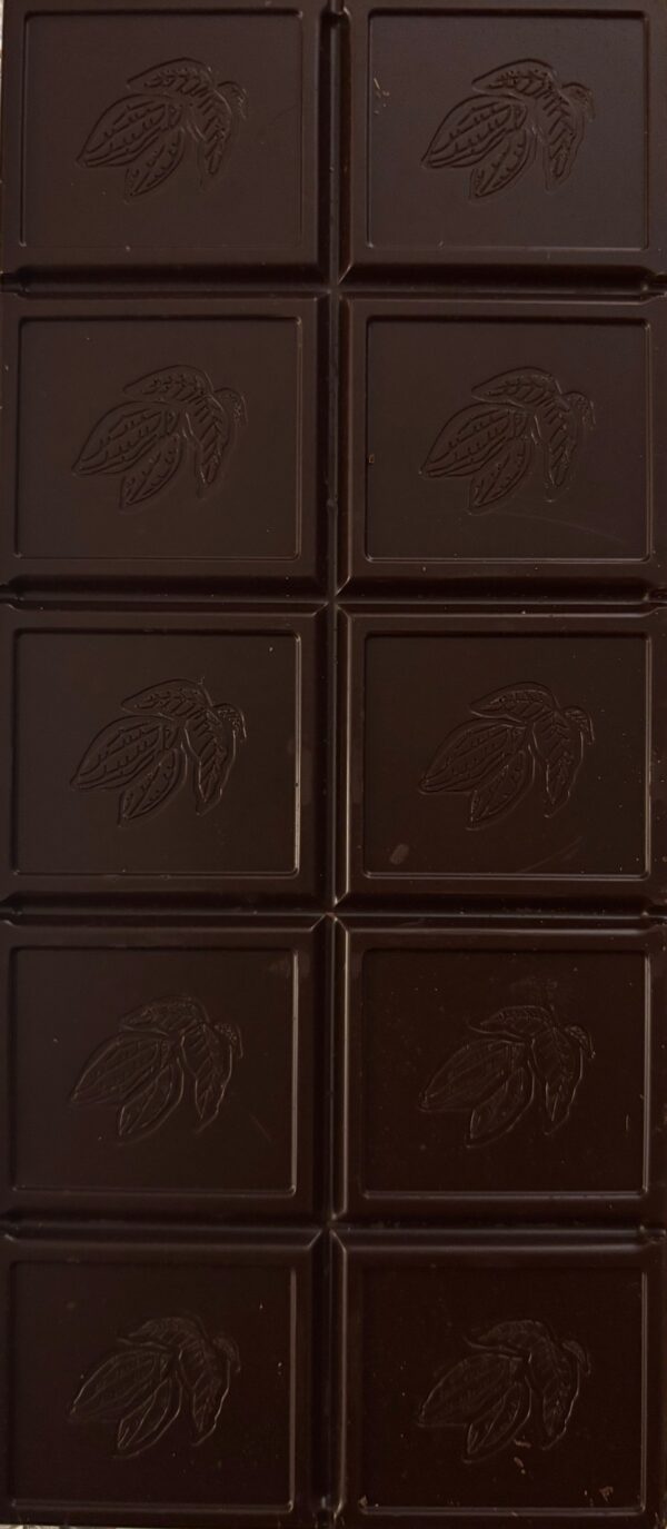 Unwrapped Idyllique chocolate bar showing 10 blocks of chocolate with a cocoa bean imprinted on each block